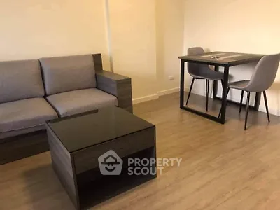 Modern living room with sleek furniture and wooden flooring, perfect for cozy gatherings.