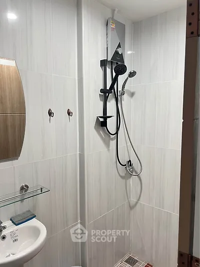 Modern bathroom with sleek shower and elegant tile design, perfect for a contemporary home.