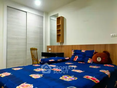 Cozy bedroom with vibrant bedding and modern furnishings in a stylish apartment.
