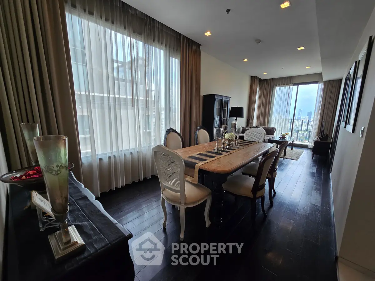 Luxurious dining and living area with elegant furnishings and city view, perfect for sophisticated urban living.