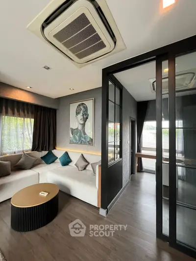 Modern living room with stylish decor and large windows for natural light