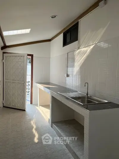 Modern kitchen with sleek countertops and ample natural light