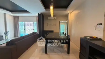 Spacious modern living room with sleek dining area and large windows for natural light.