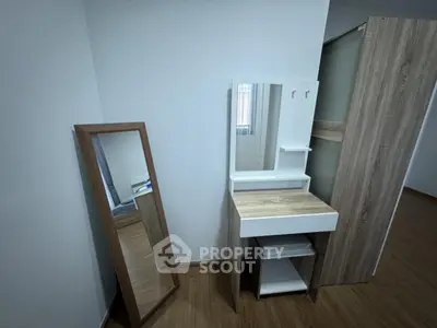 Modern bedroom with stylish wooden furniture and large mirror