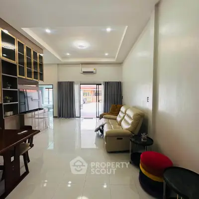 Spacious living room with modern furniture and large windows for natural light.