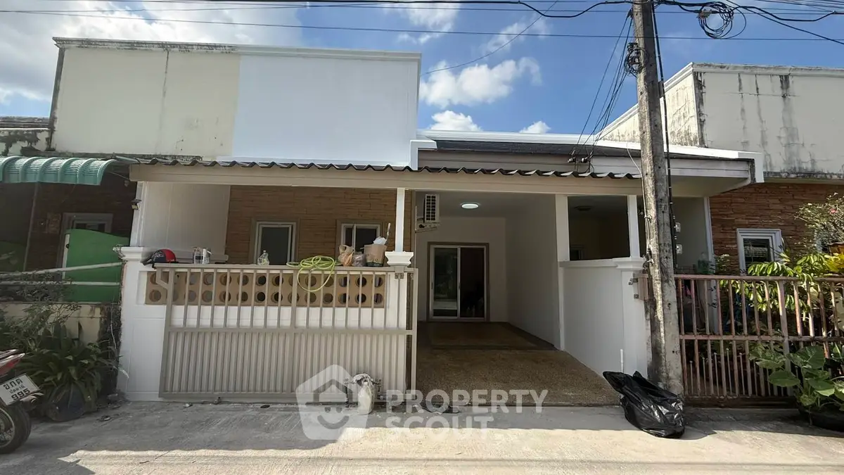 Charming single-story home with a cozy front porch and modern facade under a clear blue sky.