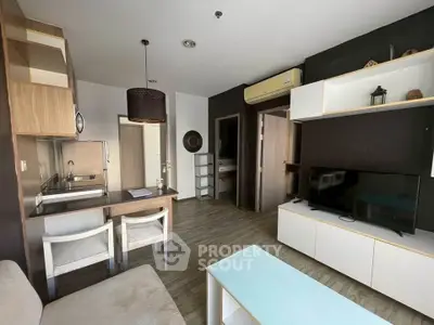 Modern living room with stylish furniture and open kitchen layout in a cozy apartment.