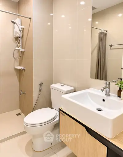 Modern bathroom with sleek fixtures and a spacious shower area.