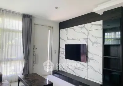 Modern living room with marble accent wall and sleek TV setup