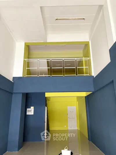 Spacious two-story interior with modern design and vibrant colors, perfect for versatile living or commercial use.