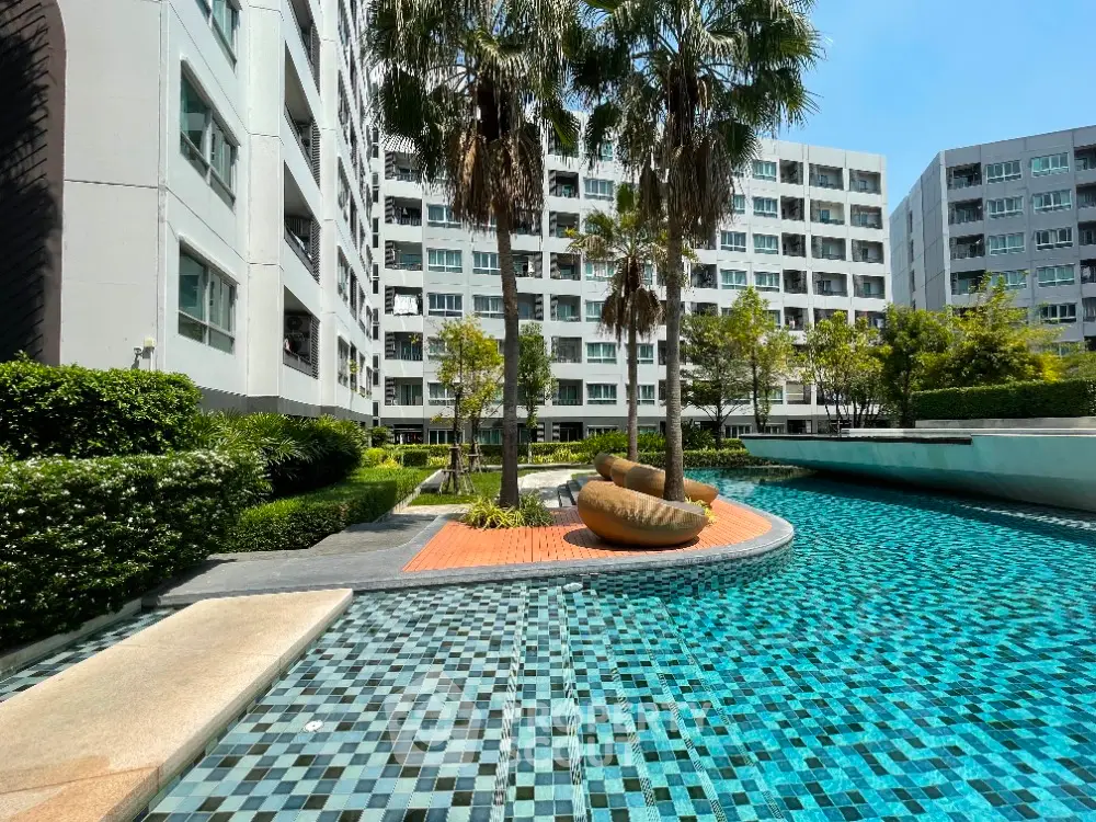 Luxurious condominium with stunning pool and lush greenery, perfect for relaxation and modern living.