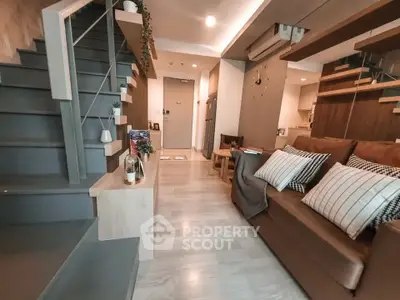 Modern living room with stylish staircase and cozy seating area