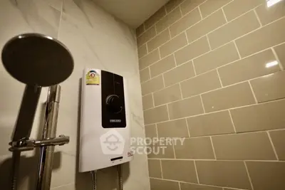 Modern bathroom with sleek showerhead and water heater on tiled wall.