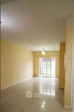 Spacious empty living room with large windows and glossy floors