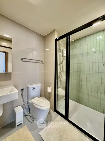 Modern bathroom with glass shower and sleek fixtures