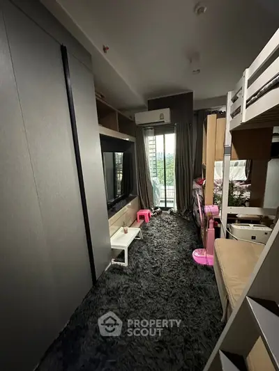 Modern living room with plush carpet and balcony view