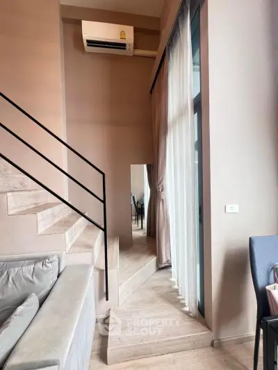 Modern duplex interior with stylish staircase and cozy seating area