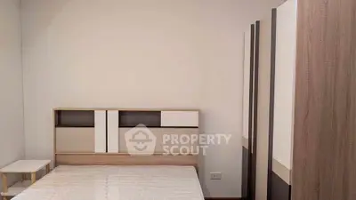 Modern minimalist bedroom with stylish wooden furniture and neutral tones.