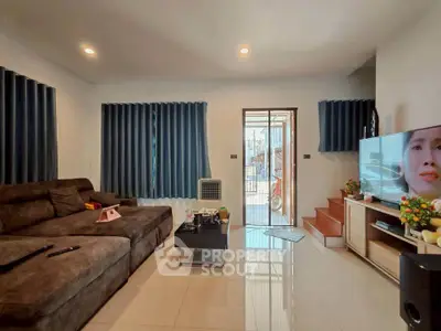 Spacious living room with modern decor and large windows for natural light.