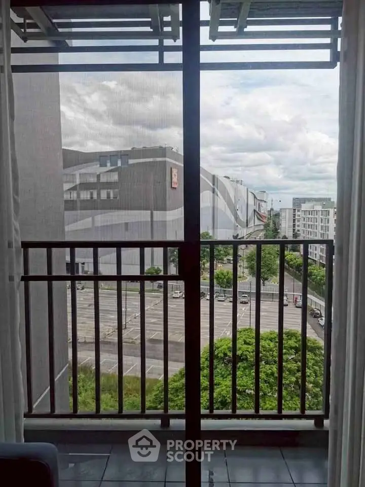 Urban view from balcony with modern architecture and lush greenery