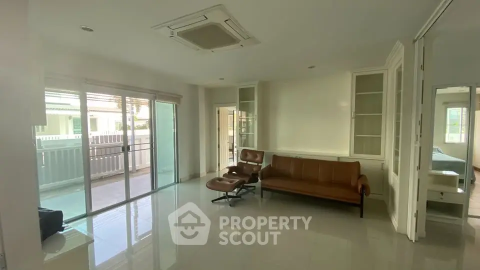 Spacious living room with modern furniture and large balcony access