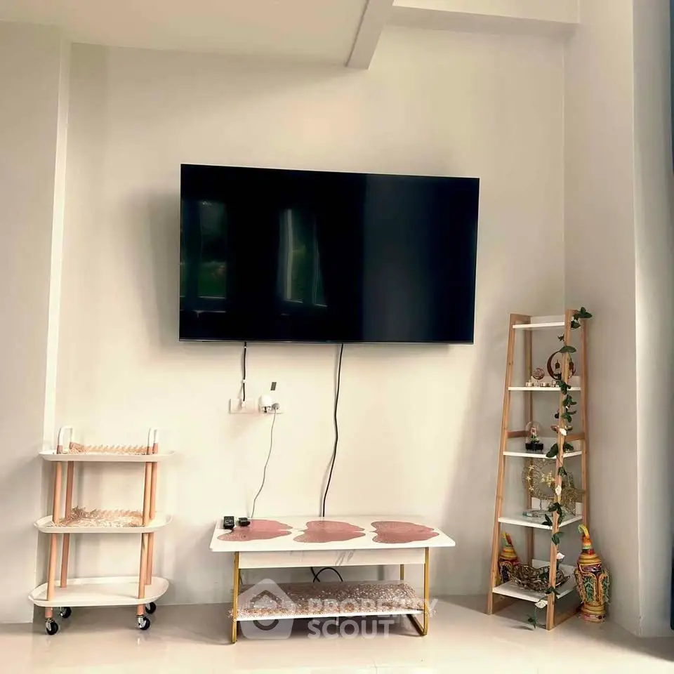 Modern living room with wall-mounted TV and stylish decor