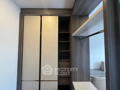 Modern bedroom with sleek built-in wardrobe and shelving