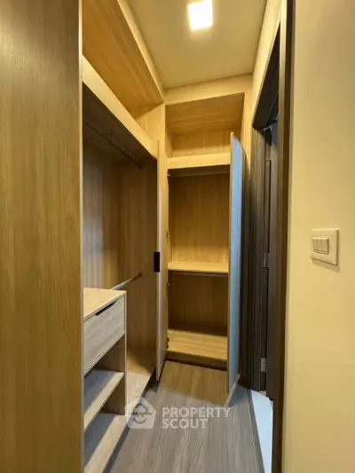 Spacious walk-in closet with wooden shelves and ample storage space.