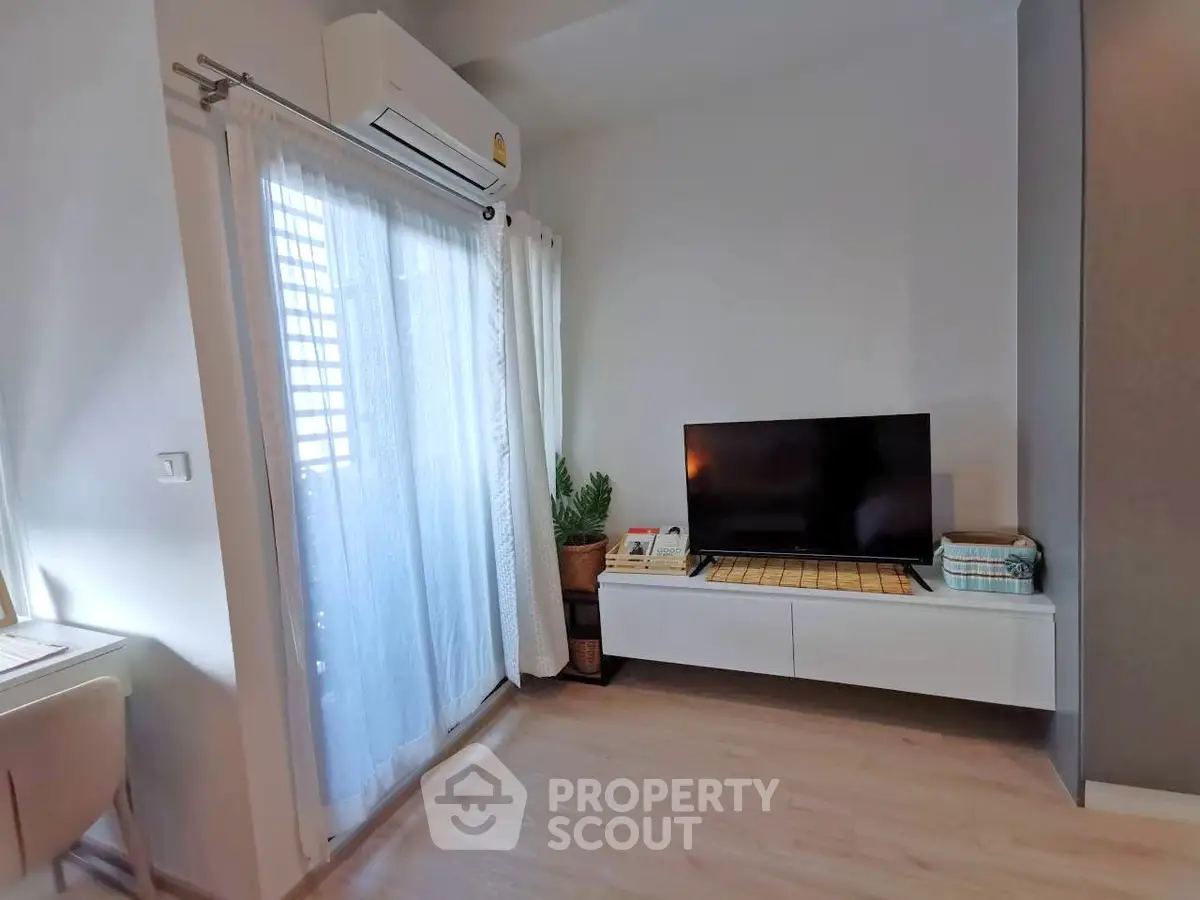 Modern living room with sleek TV setup and natural light