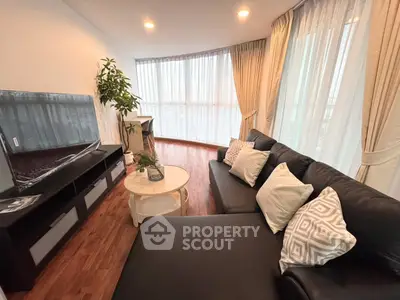 Stylish living room with modern decor and large windows offering natural light.
