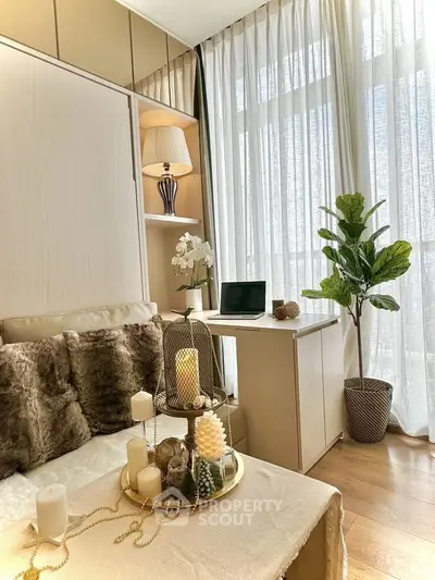 Cozy bedroom with natural light, elegant decor, and a small workspace by the window.