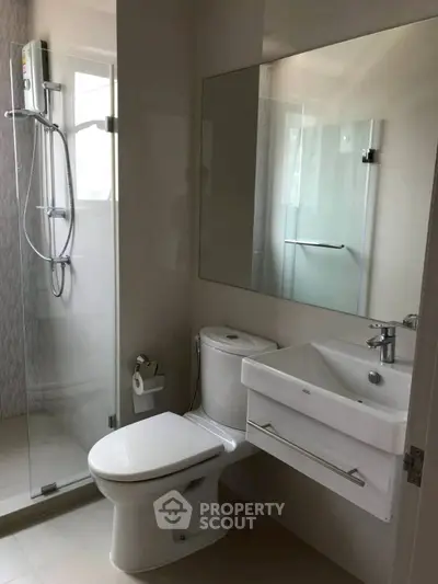 Modern bathroom with glass shower and sleek fixtures