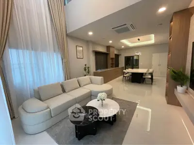 Luxurious modern living room with elegant furniture and open dining area