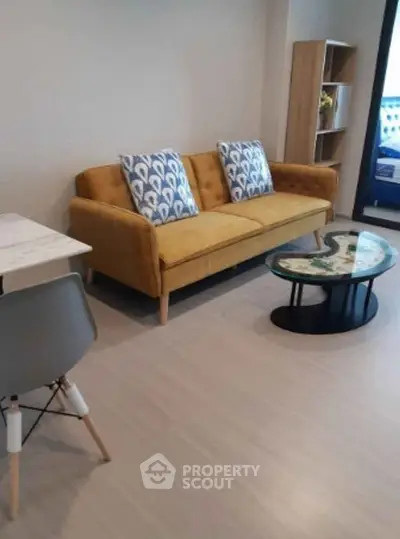 Modern living room with stylish yellow sofa and chic coffee table in cozy apartment.