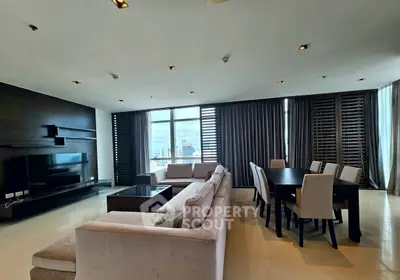 Luxurious living room with modern furniture and stunning city view, perfect for entertaining guests.