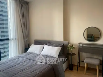 Modern bedroom with stylish decor and city view, featuring a cozy bed and elegant furnishings.