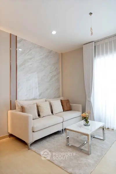 Modern living room with elegant sofa and marble accent wall
