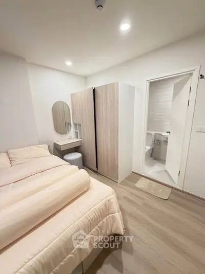 Cozy bedroom with ensuite bathroom, featuring modern wardrobe and soft lighting for a relaxing ambiance.