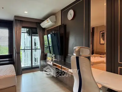 Modern living room with sleek design, large TV, and balcony access in a stylish apartment.