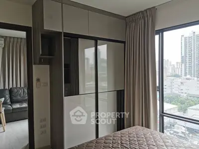 Modern bedroom with city view and sleek built-in wardrobe