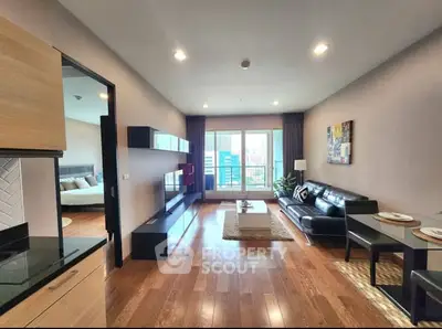 Spacious modern living room with wooden flooring and balcony view