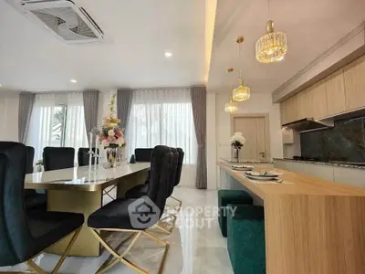 Luxurious dining area with elegant decor and modern kitchen in open layout