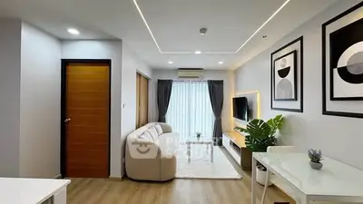 Modern living room with stylish decor, cozy seating, and natural light.