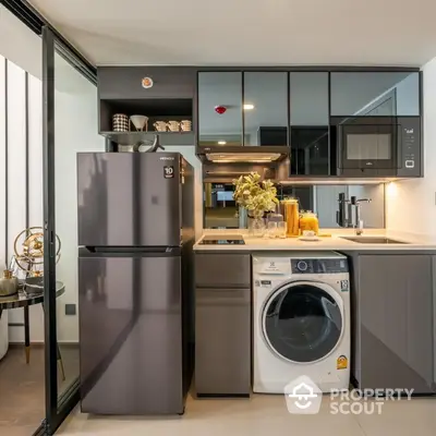 Modern kitchen with stainless steel appliances, sleek cabinetry, and a cozy breakfast nook, perfect for urban living.