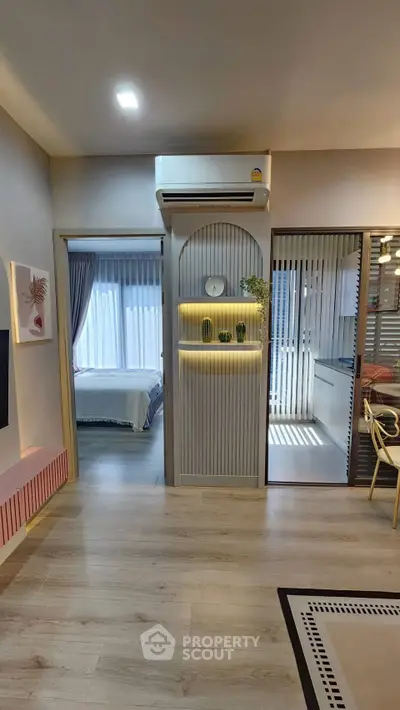 Modern apartment interior with stylish decor, featuring a cozy bedroom and open living area with natural light.