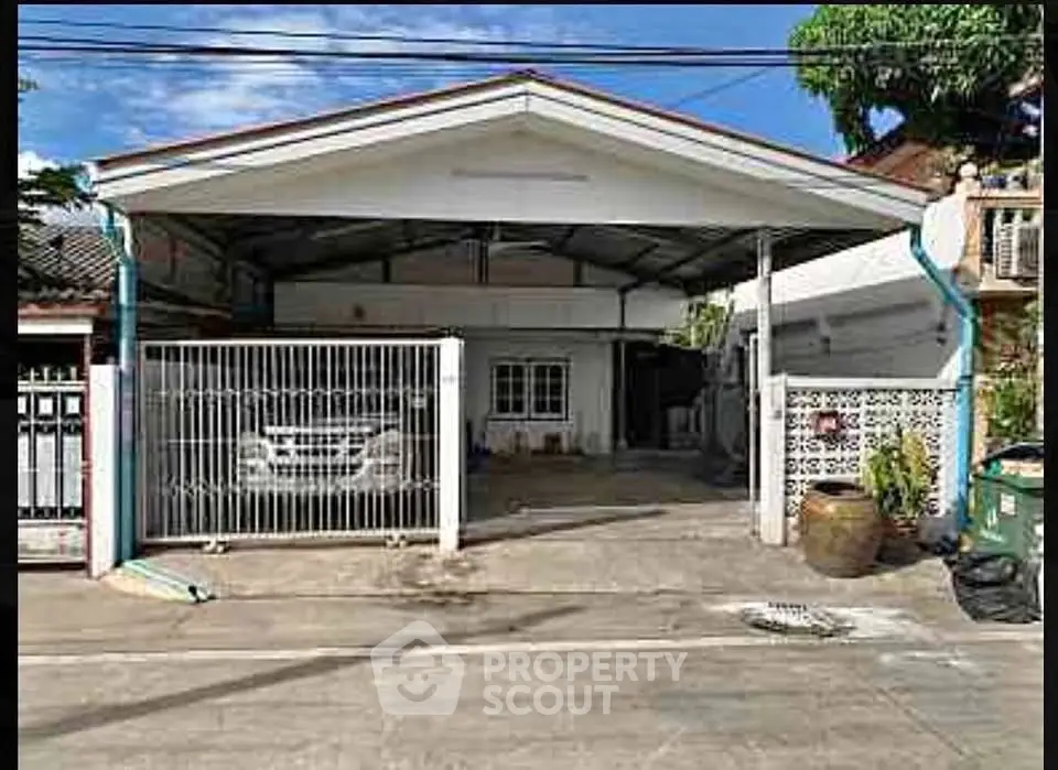 Charming single-story home with carport and gated entrance in a quiet neighborhood.