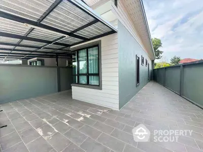 Modern exterior of a stylish home with spacious tiled patio and sleek design.