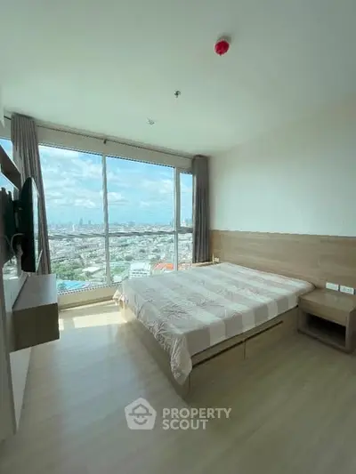 Spacious bedroom with panoramic city view and modern furnishings