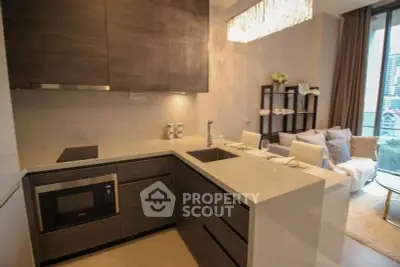 Modern kitchen with sleek cabinetry and open layout adjacent to cozy living area with city view.