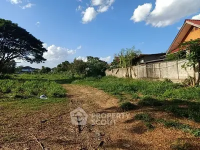 Spacious plot of land with lush greenery and clear blue sky, ideal for development opportunities.